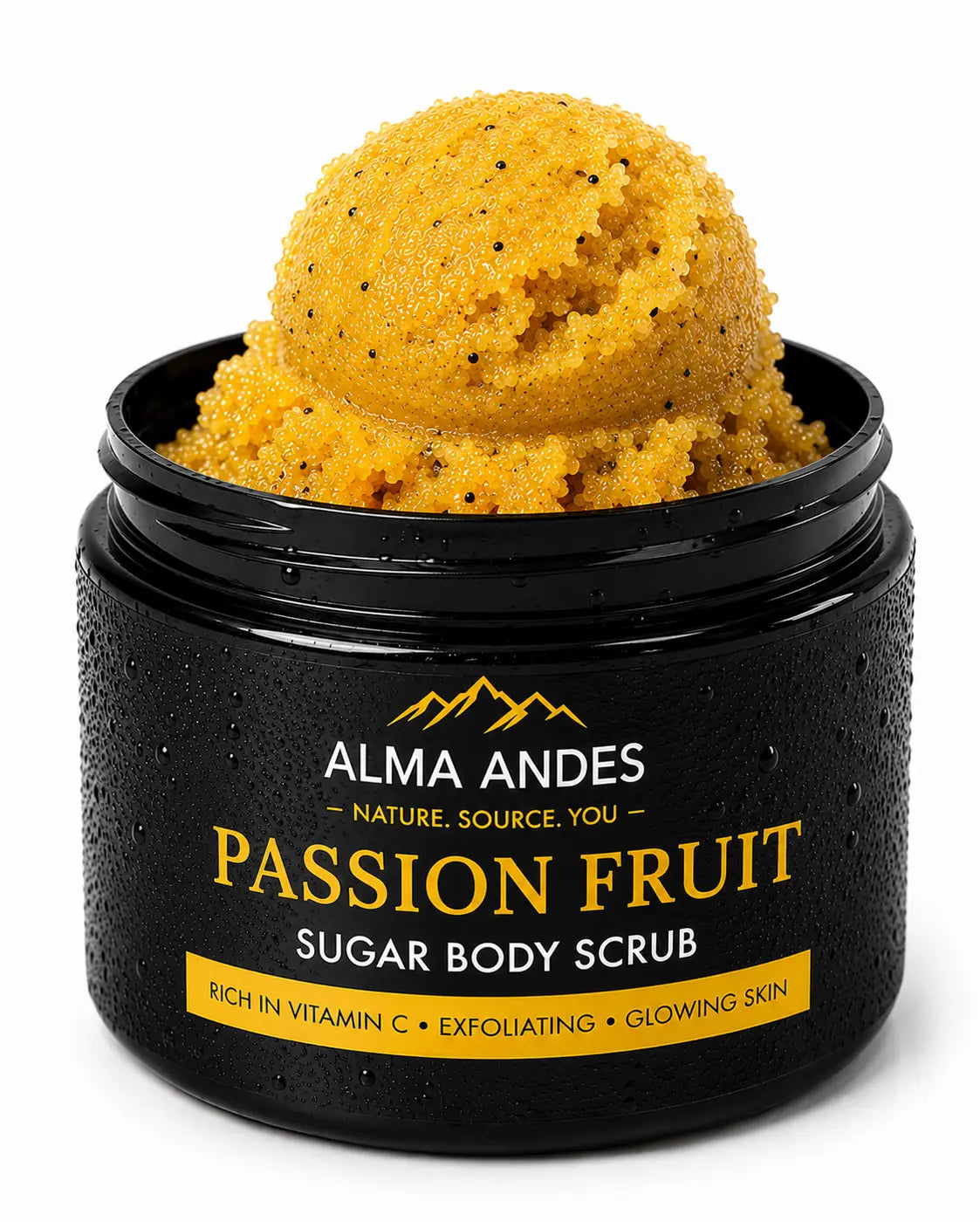 An open black jar of Alma Andes Passion Fruit Sugar Body Scrub, showing a scoop of yellow-orange scrub with small dark specks, on a clean white background.