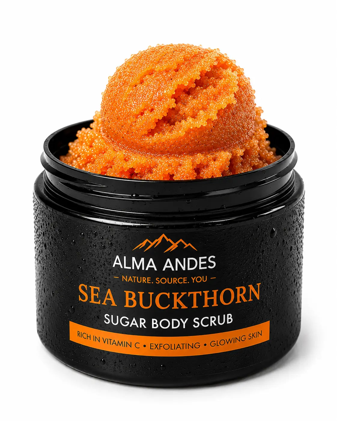 Alma Andes Sea Buckthorn Sugar Body Scrub in a black jar with a scoop of orange scrub visible on top, shown on a white background.