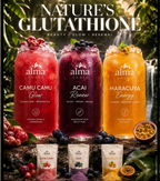 Three jars of 'Alma Andes' juices with ingredients and packaging on a natural background.Tropical smoothie made with Camu Camu, Acai and Maracuya superfood powders