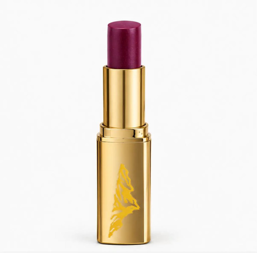 Gold lipstick case with purple lipstick on a white background