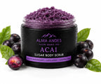 Acai sugar body scrub in a black jar with acai berries and leaves on a white background